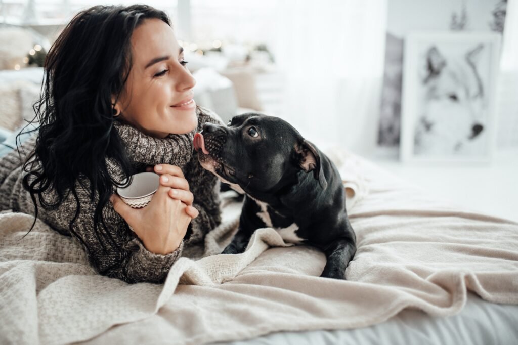 Mujer jugando con su perro negro